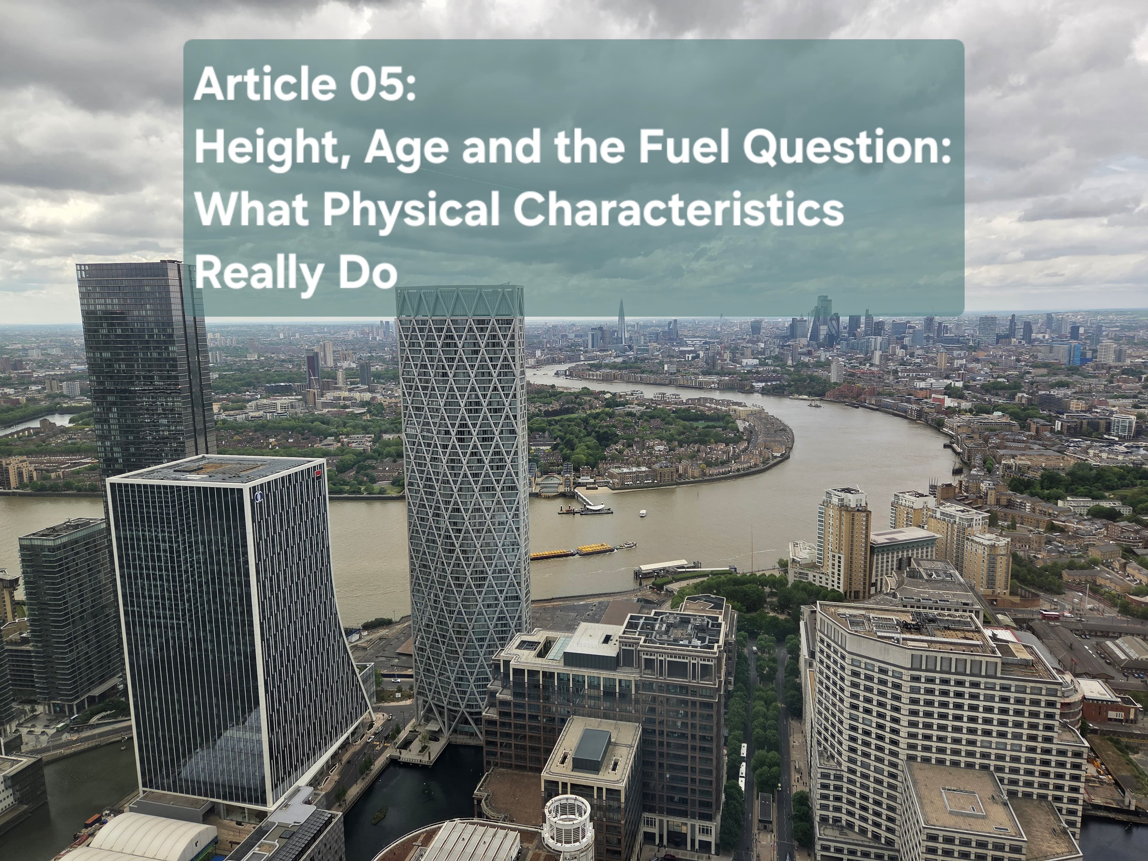 Aerial view of Canary Wharf office towers beside the River Thames under a cloudy sky, the title card for Article 05 on how height, age and fuel type affect office energy use.