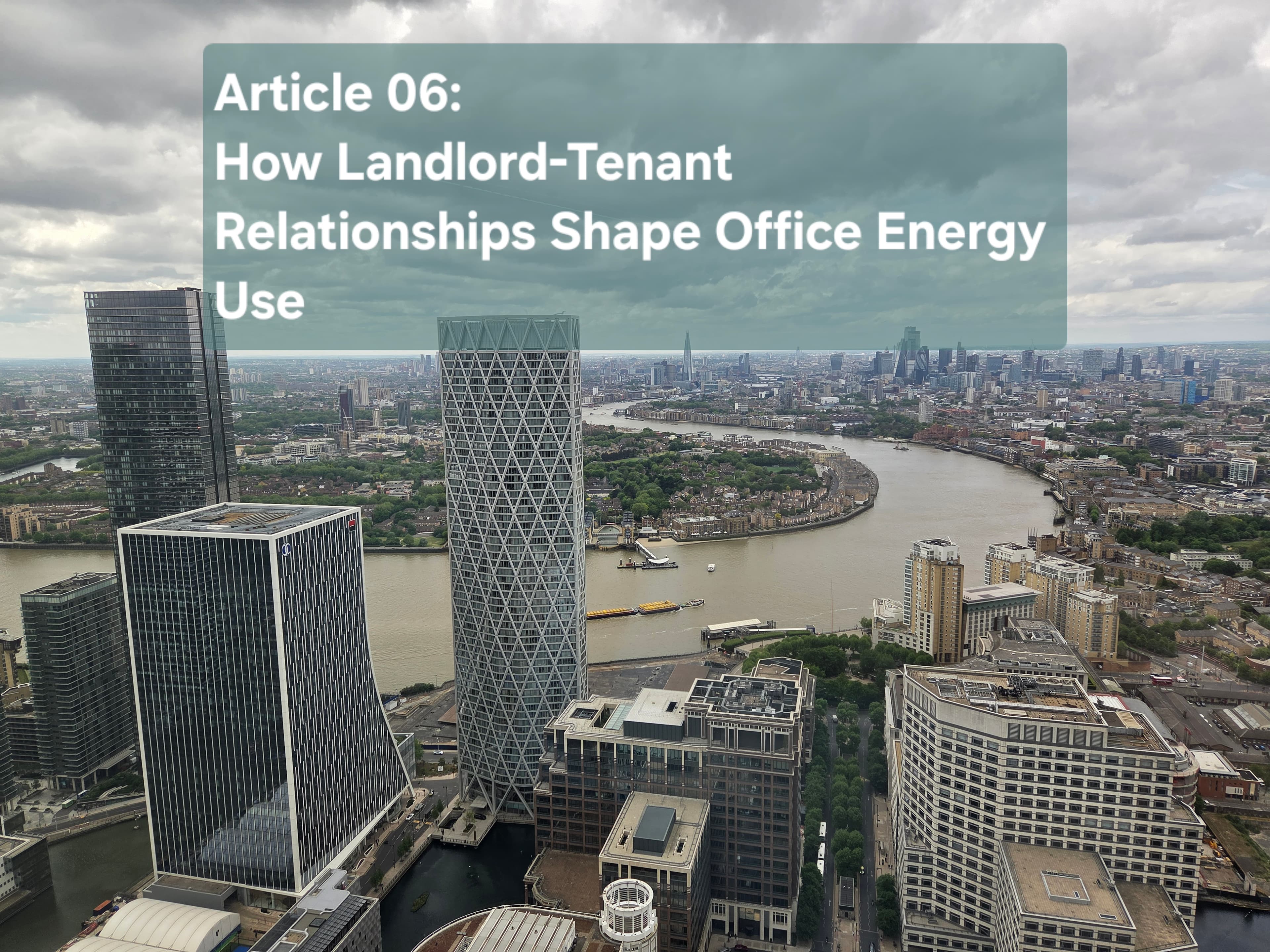 Aerial view of Canary Wharf office towers beside the River Thames under a cloudy sky, the title card for Article 06 on how landlord and tenant relationships shape office energy use.